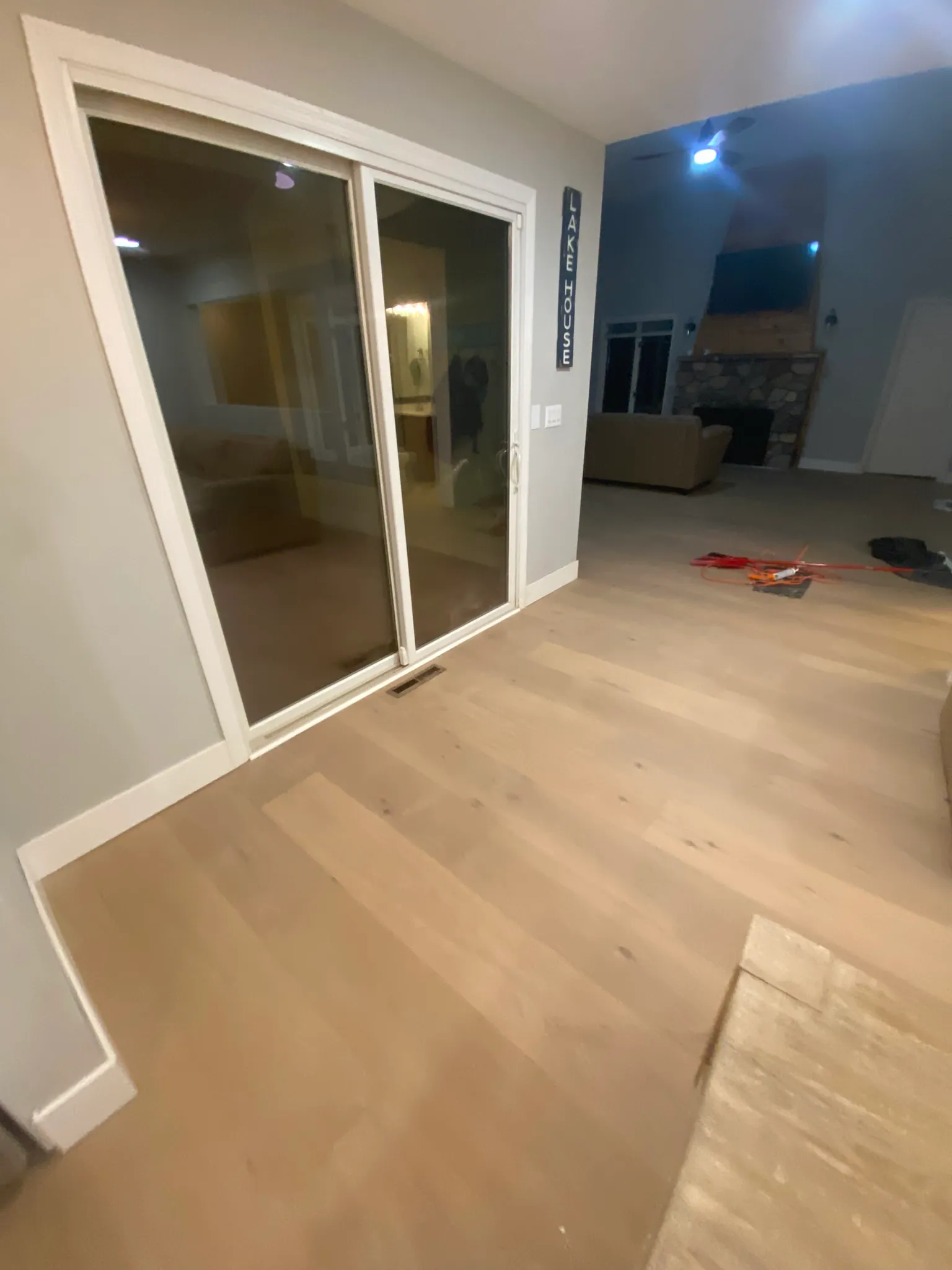 Bright open living space with newly installed white-oak luxury vinyl plank flooring