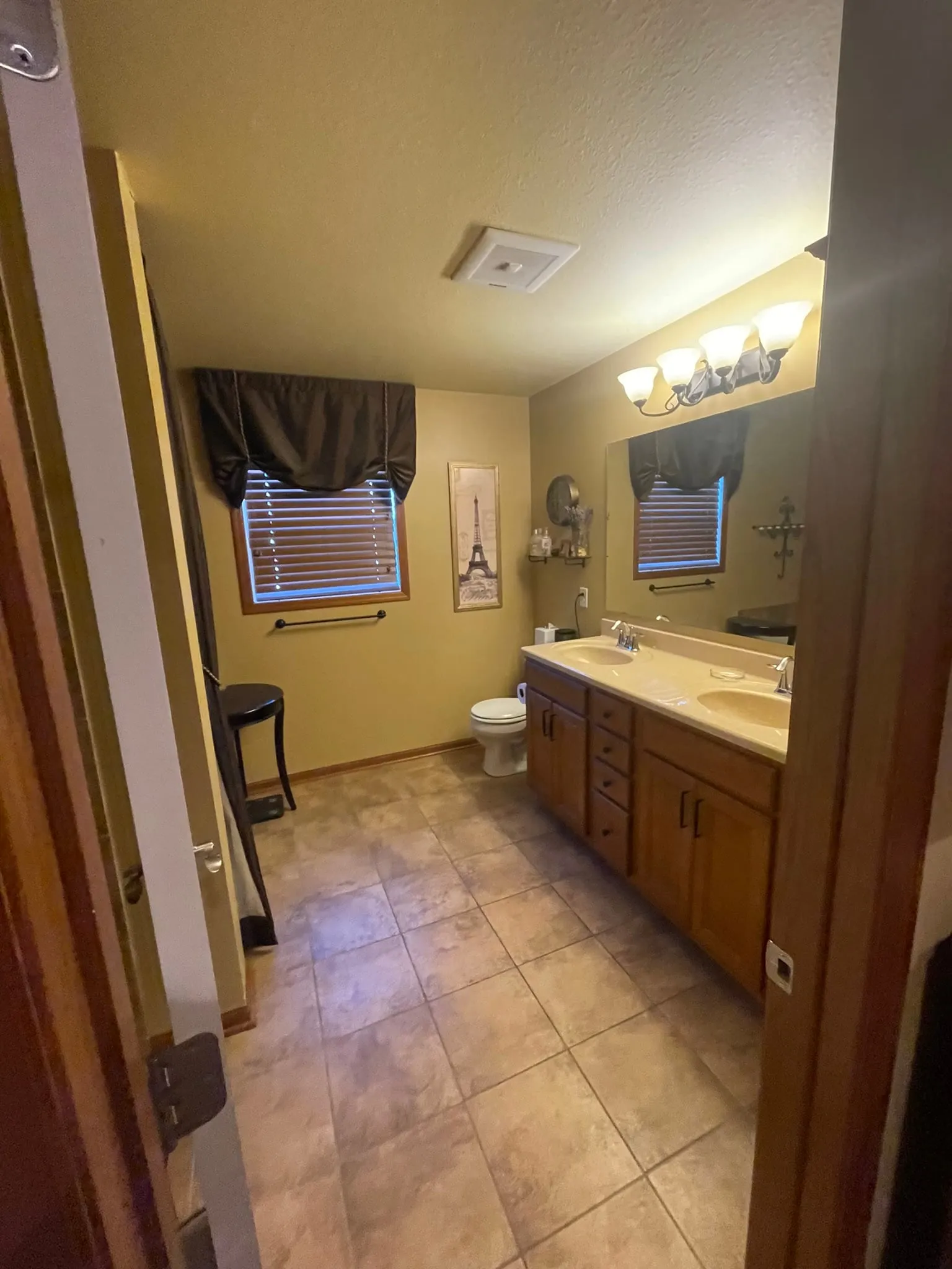 Dated bathroom with double vanity before remodel