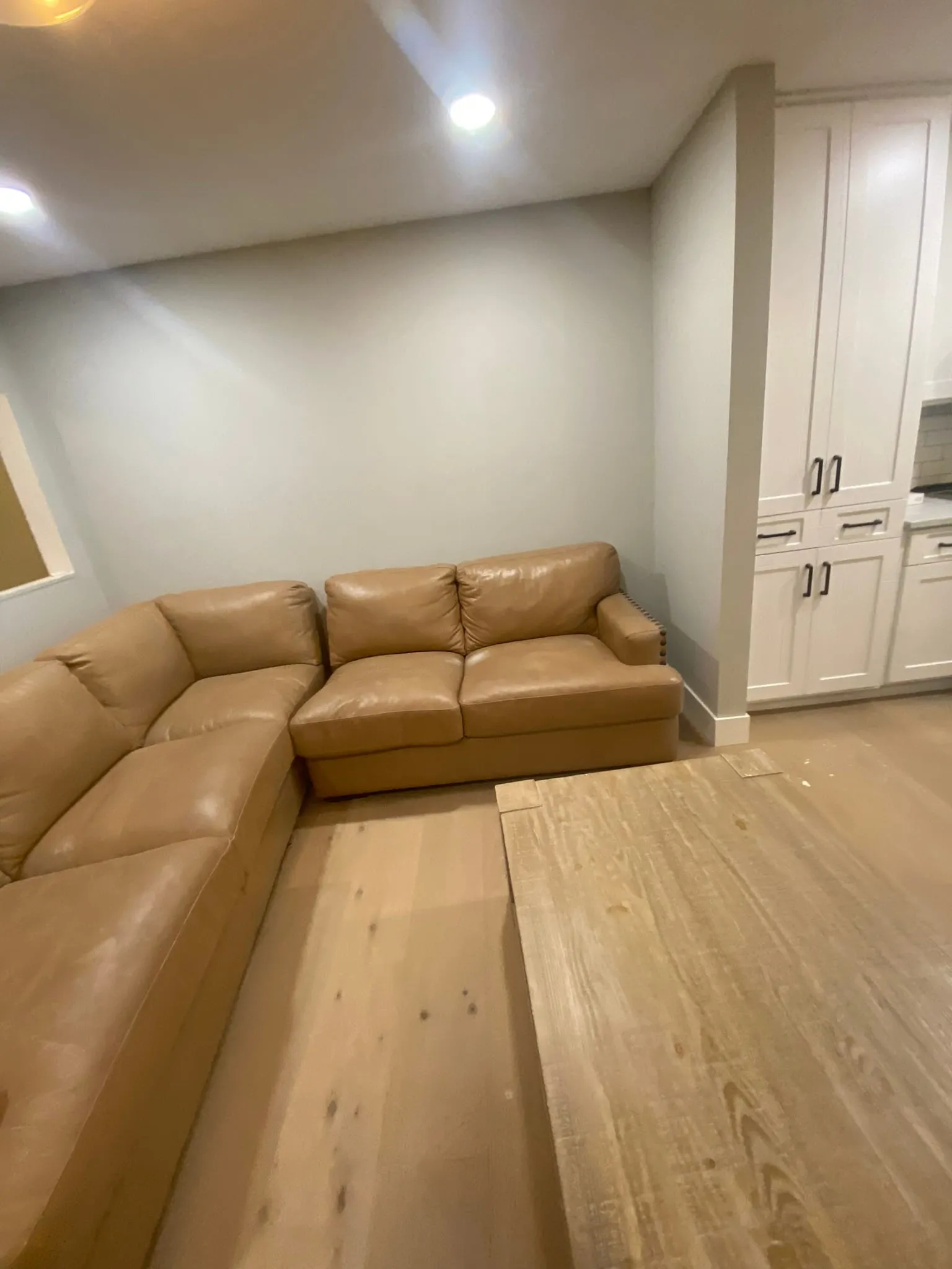 Engineered hardwood planks being installed in living room
