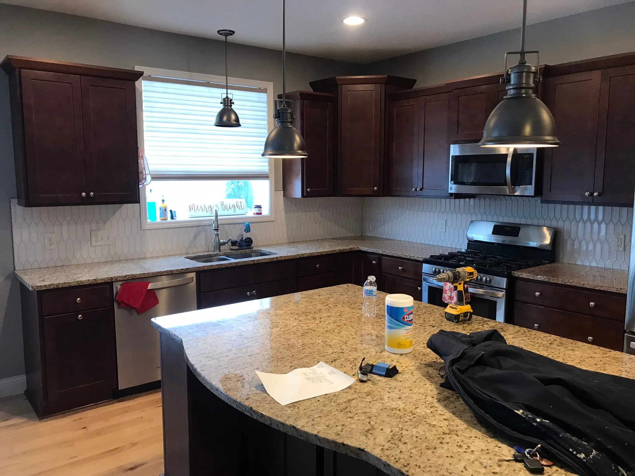 Kitchen with completed picket backsplash and pendants