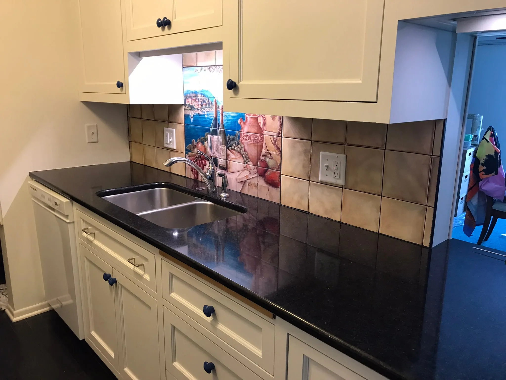 Tuscan tile mural backsplash over double sink