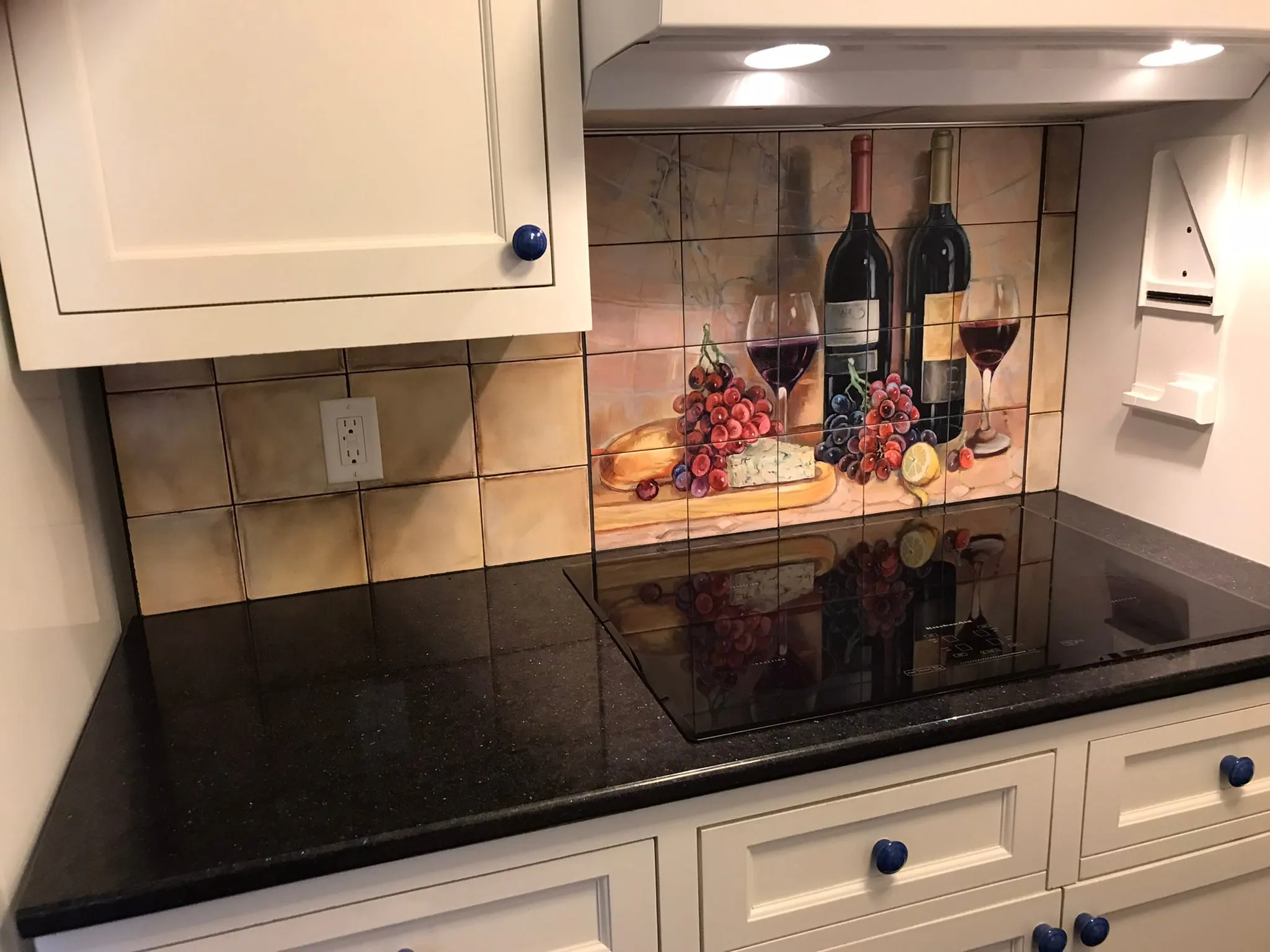Wine and grapes tile mural behind cooktop