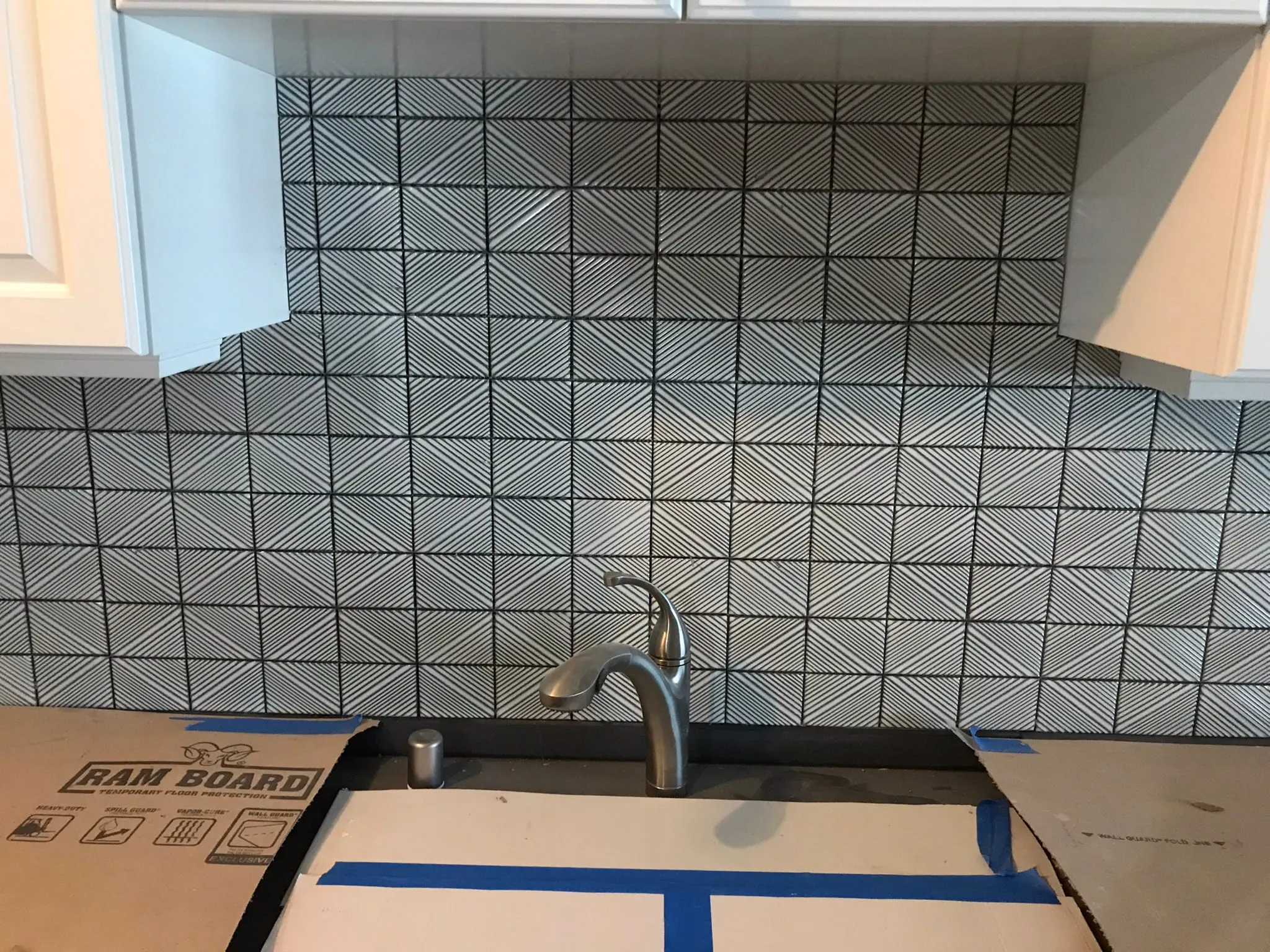 Black and white geometric tile backsplash finished