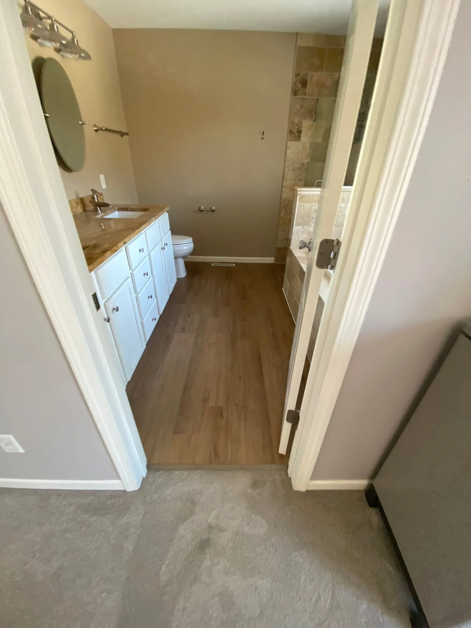Bathroom with finished LVP wood-look flooring