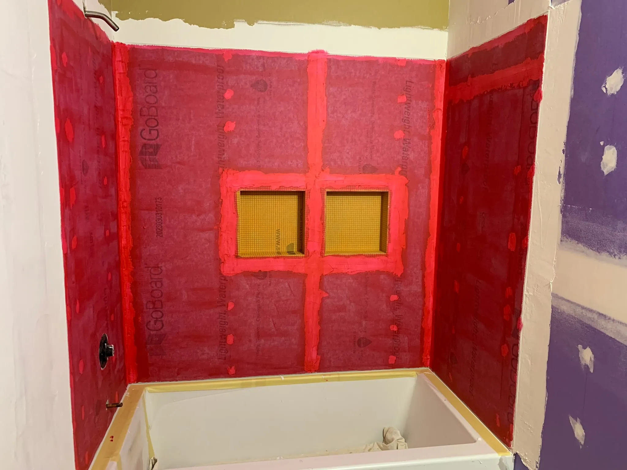 Waterproofed tub surround with niche before tile