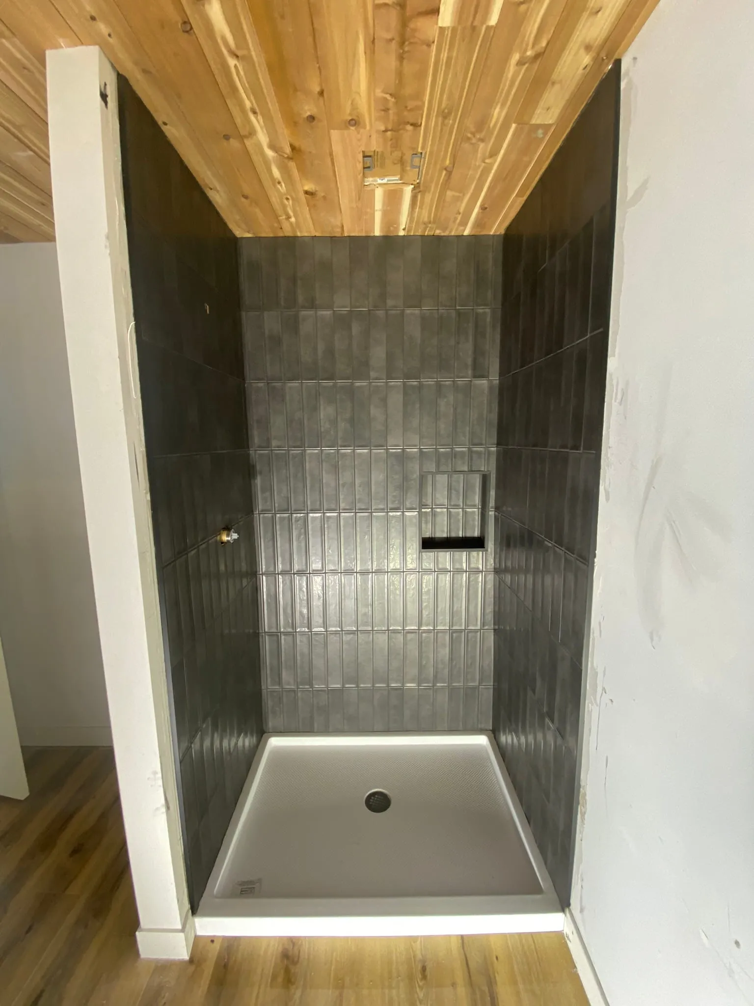 Finished charcoal stacked-tile walk-in shower with cedar ceiling